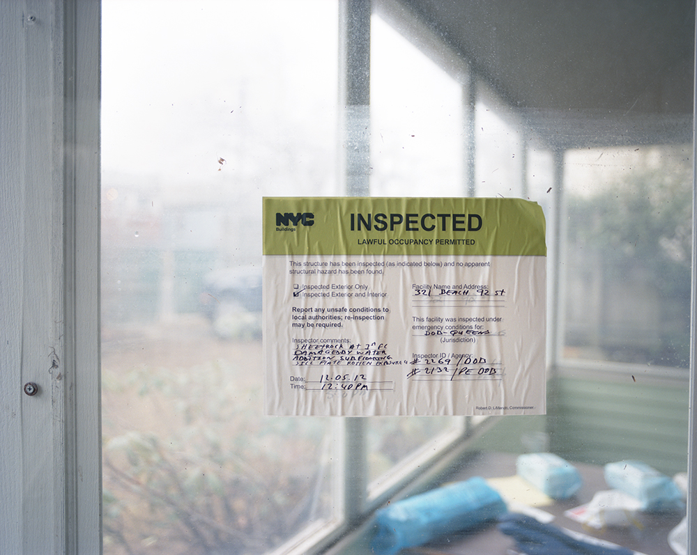 Susannah Ray<br /> <em>Inspection Sticker, Home of Clare Hilger and Jeremy Jones, Rockaway Beach, NY, December</em>, 2012<br /> Digital C-prints<br /> 24 x 30" &nbsp; &nbsp;Edition of 10<br /> 40 x 50" &nbsp; &nbsp;Edition of 5