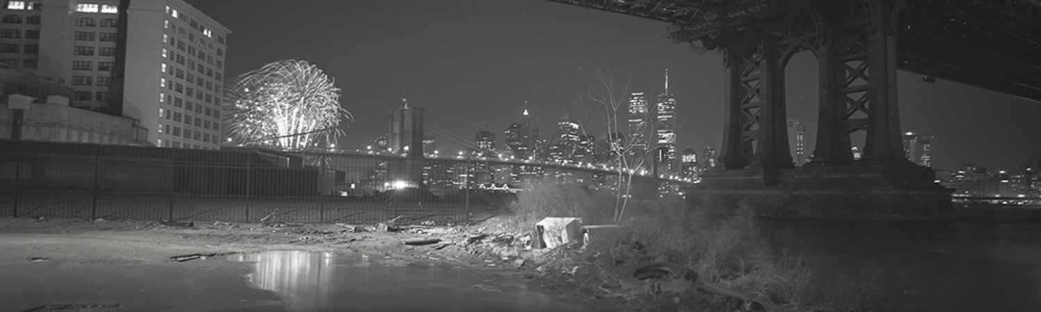 Jed Devine<br /> <em>New Year’s Fireworks Below the Manhattan Bridge,</em><br /> <em>from John Street, Brooklyn, 1998</em><br /> 2 x 6.5", Platinum-palladium print on Japanese rice paper