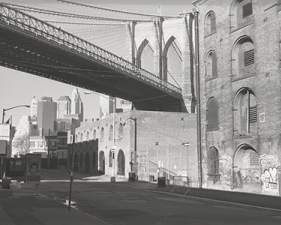 Jed Devine<br /> <em>Brooklyn Bridge Above Riverfront Buildings,&nbsp;</em><br /> <em>from Water Street, Brooklyn, 2007</em><br /> 2 x 6.5", Platinum-palladium print on Japanese rice paper